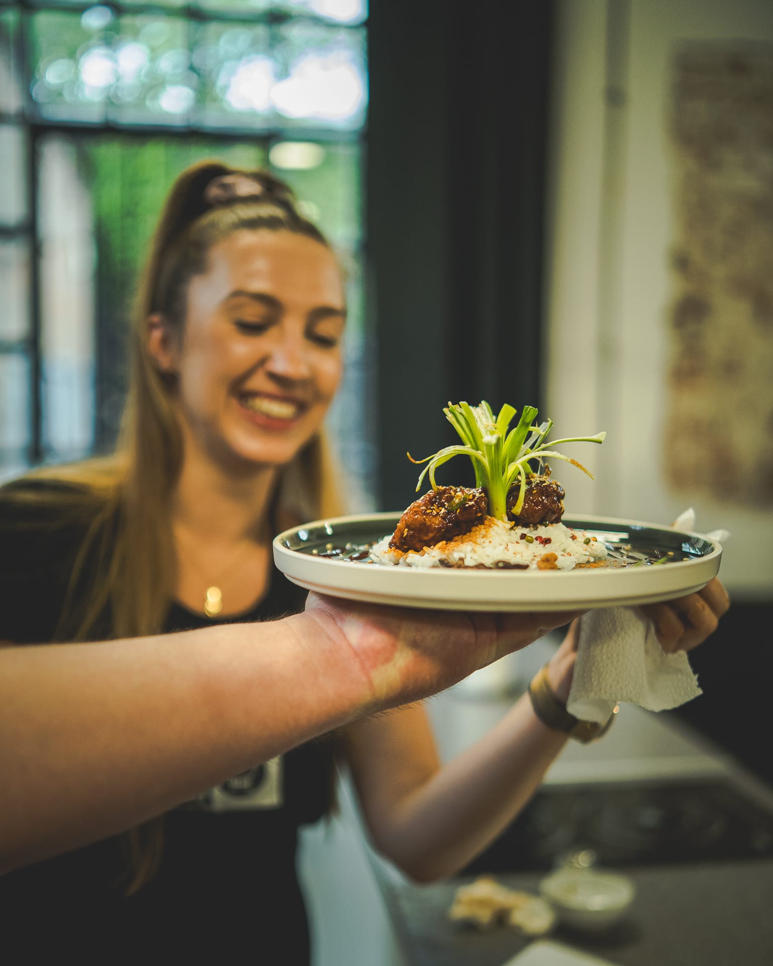 Team member presenting a dish at a team dinner
