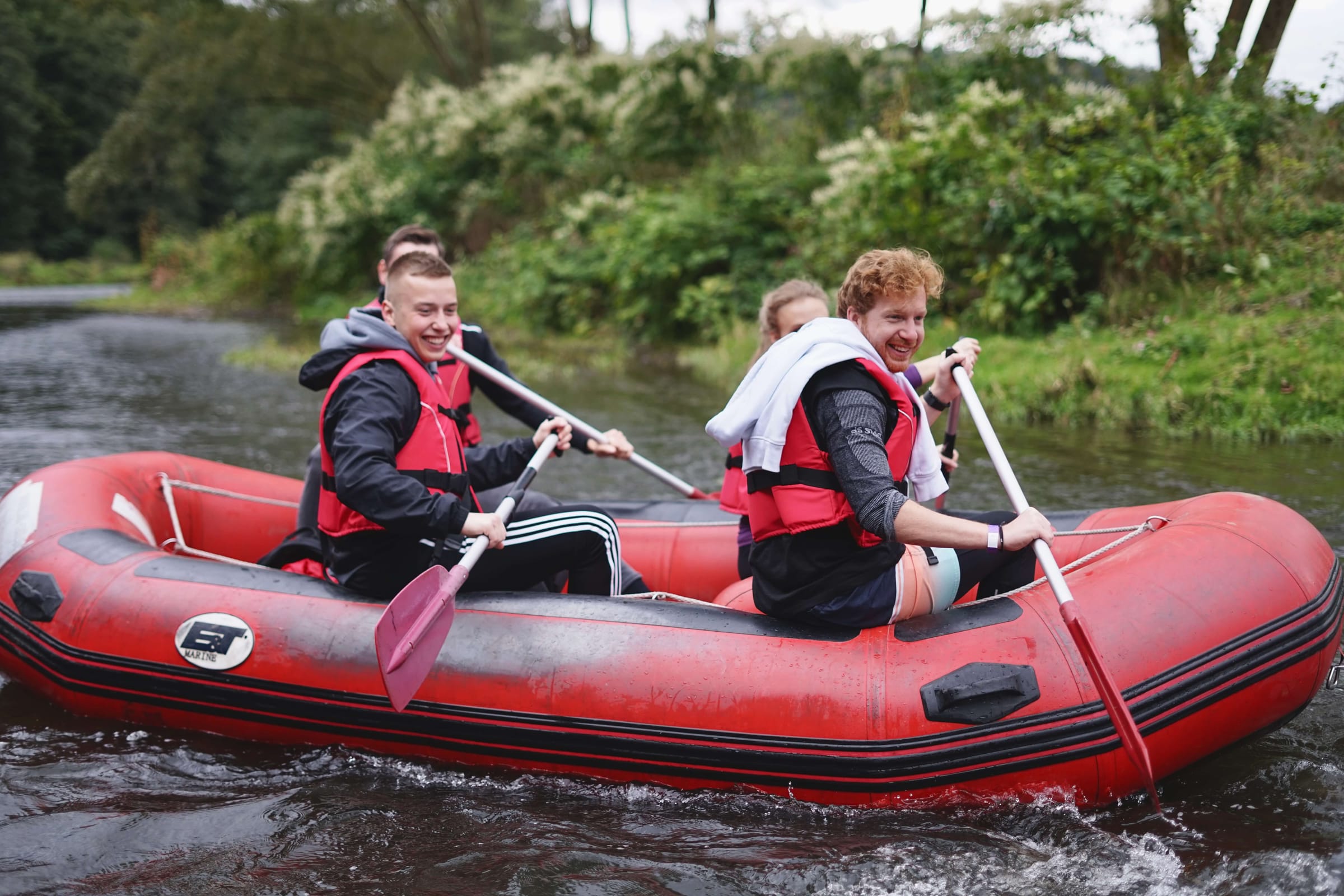 Team members rafting together at an offsite